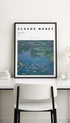 Framed Claude Monet print on a wall above a table with a chair.
